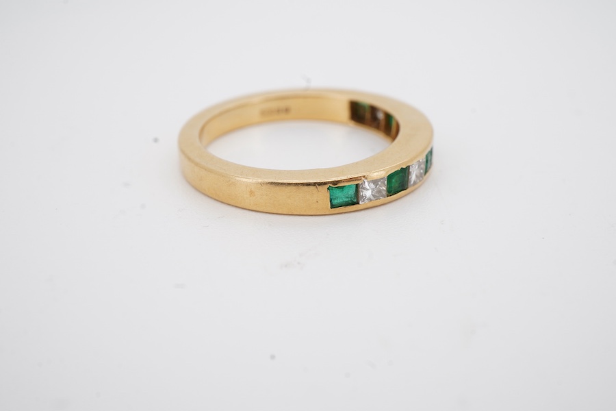 A recent 18ct gold, six stone emerald and five diamond set half hoop ring, size M, gross weight 4.3 grams.